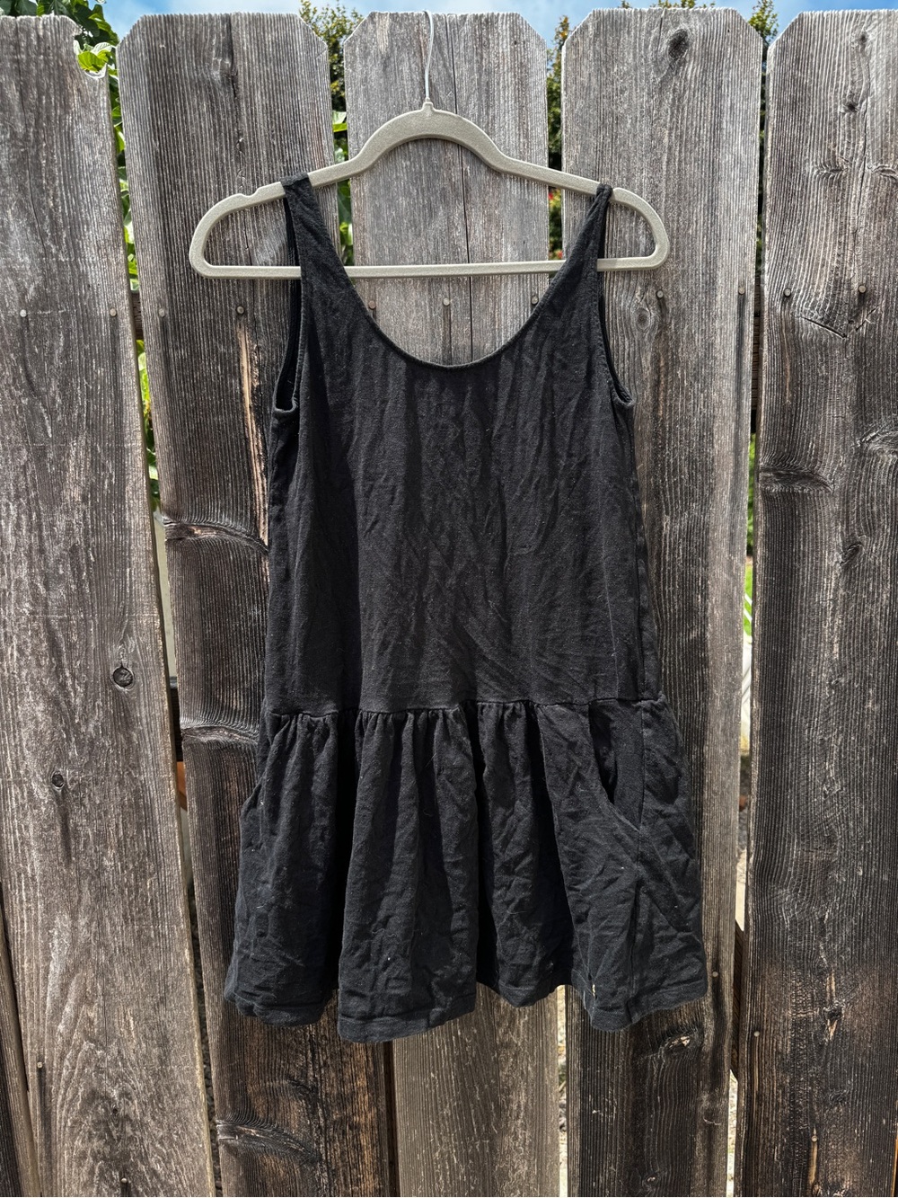 Black Sleeveless Drop Waist Mini Dress with Ruffle Hem and Pockets